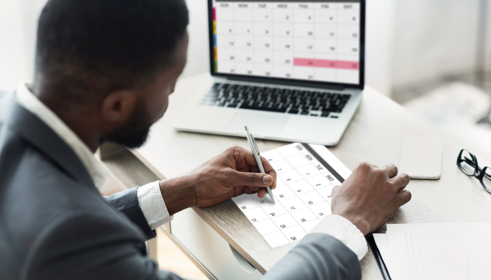 black businessman using calendar program on laptop