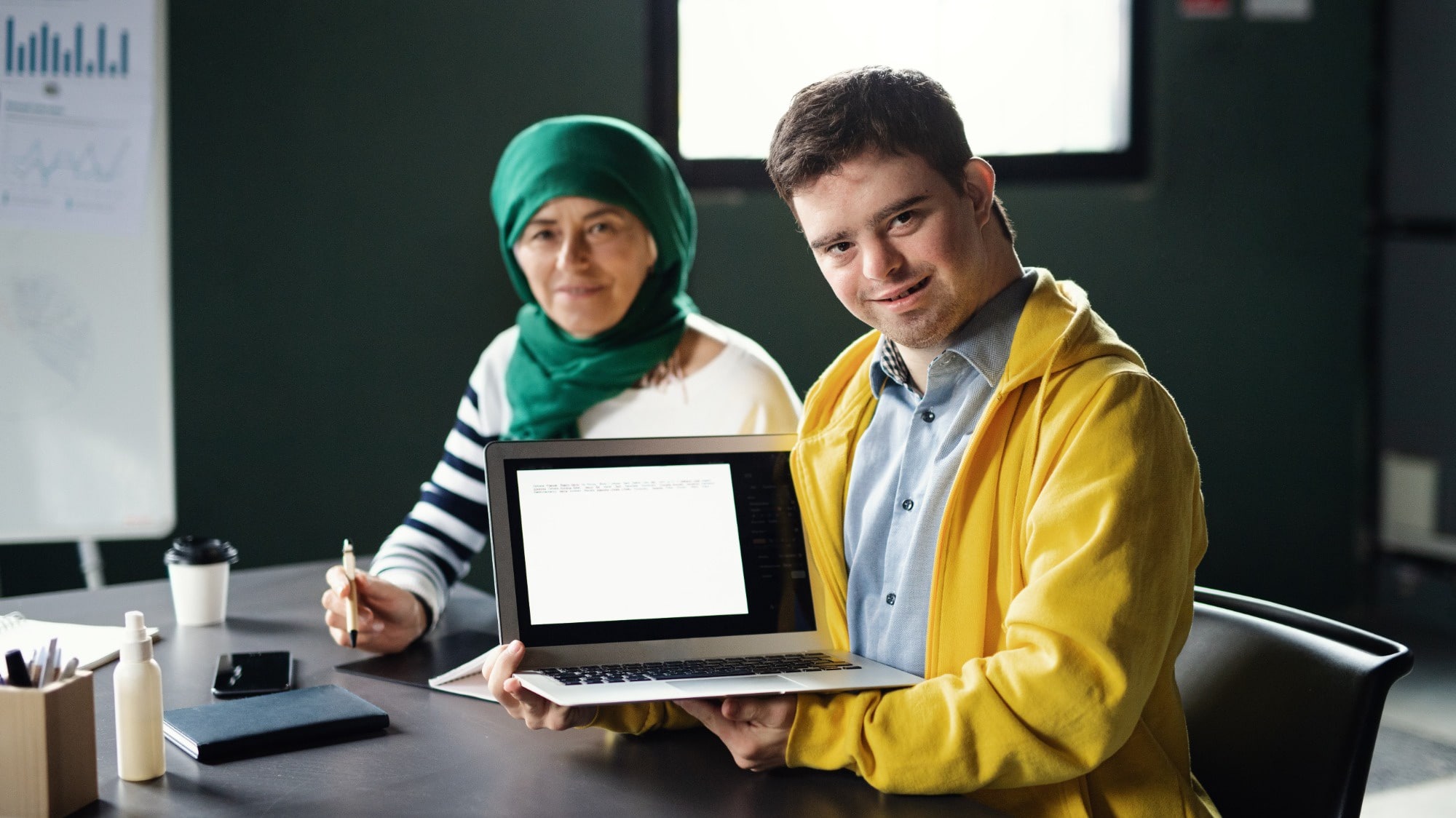 down syndrome man attending education class with laptop