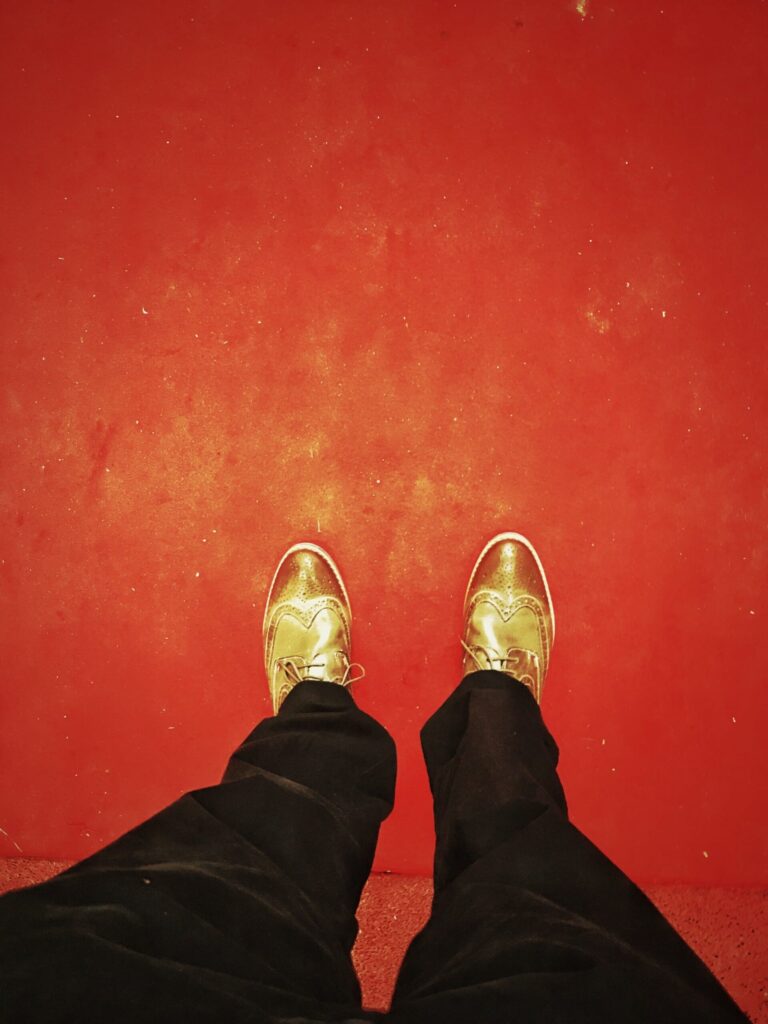 first person view looking down standing on a red carpet