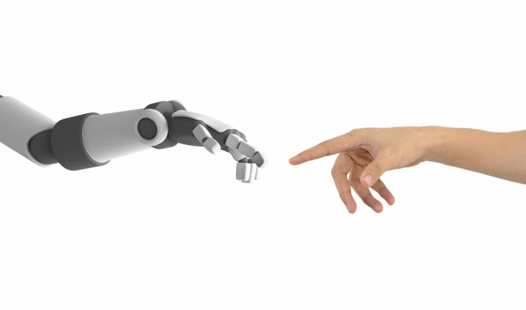 human hand and robot reaching out to touch fingers