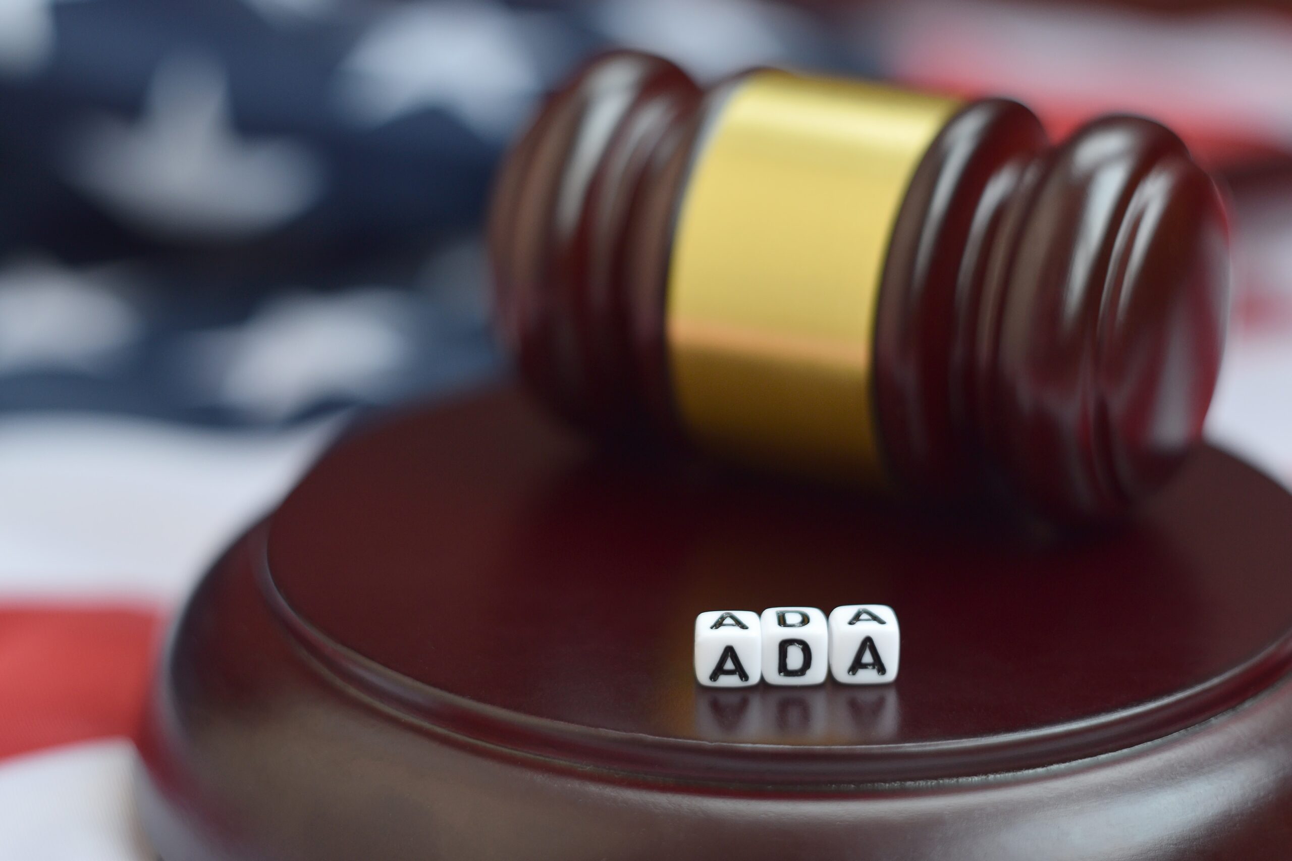 justice mallet and ada acronym close up american flag