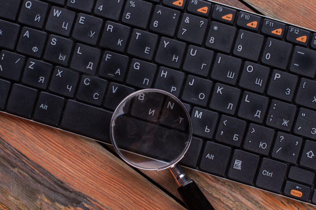 magnifying glass on black keyboard