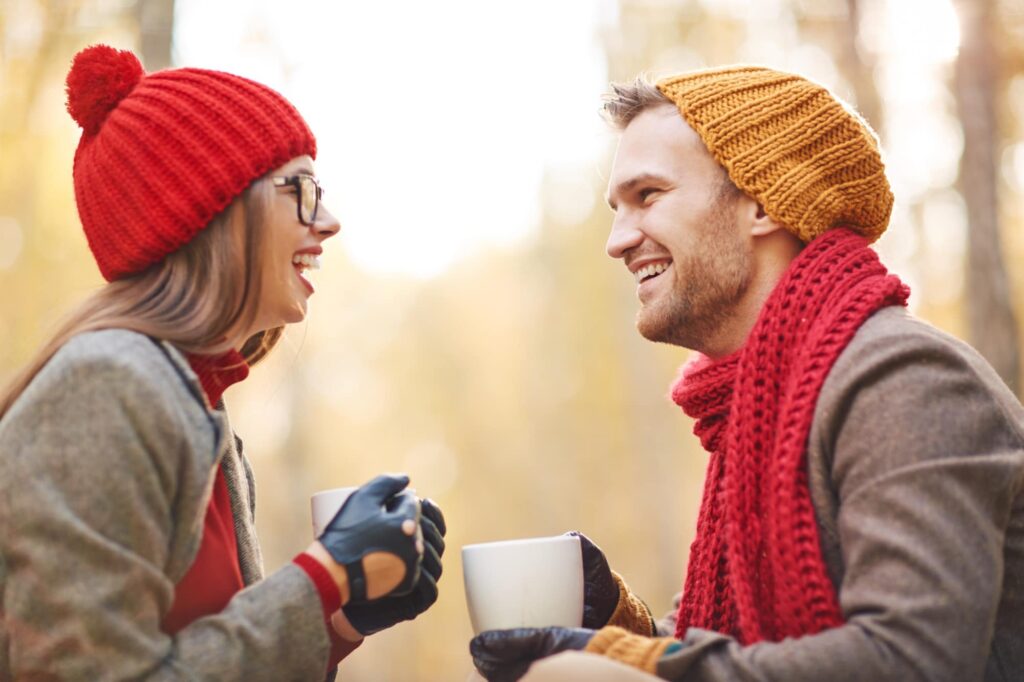 two people having a conversation in cold with coffee